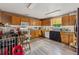 A compact kitchen featuring lots of cabinetry, laminate floors, and a stainless dishwasher at 151 Grandma Branch Rd, Grantville, GA 30220