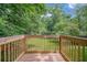 View from the back deck overlooking a yard with mature trees at 1528 Alder Sw Ln, Atlanta, GA 30311