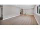 Bright and spacious living room with light gray walls, laminate flooring, and recessed lighting at 1528 Alder Sw Ln, Atlanta, GA 30311