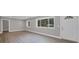 Living room with new laminate flooring, a large window and light gray walls overlooking the entryway at 1528 Alder Sw Ln, Atlanta, GA 30311