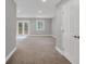 Open-concept living room with carpet flooring, recessed lighting, and access to outdoor space at 1528 Alder Sw Ln, Atlanta, GA 30311