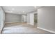 A living room featuring neutral paint, carpet, recessed lighting, and access to a glass doored walk-in shower at 1528 Alder Sw Ln, Atlanta, GA 30311