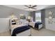 Charming bedroom featuring two twin beds with patterned pillows and stylish gray walls at 1628 Baytree Dr, Cumming, GA 30040