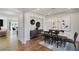 An open dining room features modern decor and lighting with hardwood flooring throughout at 1628 Baytree Dr, Cumming, GA 30040