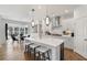 Modern kitchen with an island and chairs, stainless appliances, and an adjacent dining area at 1628 Baytree Dr, Cumming, GA 30040