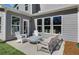 Modern patio featuring outdoor seating, a concrete firepit, and a beautiful home exterior at 1628 Baytree Dr, Cumming, GA 30040