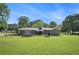 Expansive backyard featuring a covered patio, a fire pit, and a trampoline, ideal for outdoor activities at 205 Tamea Trl, Covington, GA 30014