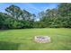 A backyard with a fire pit and a large grass area at 205 Tamea Trl, Covington, GA 30014