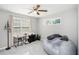 This bedroom has natural light from two windows and has a ceiling fan at 205 Tamea Trl, Covington, GA 30014