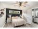 Cozy bedroom with a ceiling fan, decorative accents and a view of the backyard at 205 Tamea Trl, Covington, GA 30014