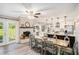 Open concept dining and kitchen area with brick fireplace, modern lighting and stainless appliances at 205 Tamea Trl, Covington, GA 30014