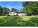 Charming single-story home with a lush green lawn and mature trees, providing a welcoming curb appeal at 205 Tamea Trl, Covington, GA 30014