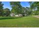 Well-maintained home with a spacious green lawn, attached garage, and a basketball hoop for outdoor activities at 205 Tamea Trl, Covington, GA 30014