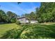 Charming single-story home with a lush green lawn and mature trees, providing a welcoming curb appeal at 205 Tamea Trl, Covington, GA 30014