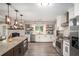 Modern kitchen with stainless steel appliances, granite countertops, and ample storage, perfect for cooking and entertaining at 205 Tamea Trl, Covington, GA 30014