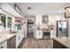 Well-lit kitchen with stainless steel appliances, granite countertops, white cabinets, and stylish backsplash at 205 Tamea Trl, Covington, GA 30014