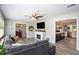 Open-concept living room with modern fireplace, comfortable seating, and seamless flow to the kitchen, ideal for entertaining at 205 Tamea Trl, Covington, GA 30014