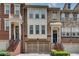 Charming townhome with brick facade, front-entry garage, and inviting entry staircase at 4905 Greylock Se Walk, Atlanta, GA 30339