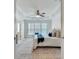 Sunlit primary bedroom boasts a tray ceiling, plush carpet, and cozy window seating at 4905 Greylock Se Walk, Atlanta, GA 30339