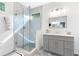 The bathroom features a glass shower and grey vanity with marble countertop at 1671 Laurel Nw Ave, Atlanta, GA 30318