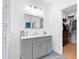 Bathroom with grey vanity, marble countertop, and view into the walk-in closet at 1671 Laurel Nw Ave, Atlanta, GA 30318