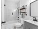 Modern bathroom features a glass-enclosed tub/shower and floating shelves for storage at 1671 Laurel Nw Ave, Atlanta, GA 30318