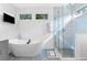 This modern bathroom features a sleek soaking tub and walk-in shower at 1671 Laurel Nw Ave, Atlanta, GA 30318