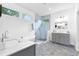 Bright bathroom features a soaking tub, glass shower, double vanity, and geometric tile at 1671 Laurel Nw Ave, Atlanta, GA 30318