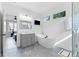 This bathroom features a modern soaking tub, glass shower, and hexagonal tile at 1671 Laurel Nw Ave, Atlanta, GA 30318