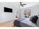 This bedroom features a TV, exercise bike, hardwood floors, and great natural light at 1671 Laurel Nw Ave, Atlanta, GA 30318