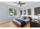 Sunlit bedroom featuring hardwood floors, stylish decor, and a large window with treetop views at 1671 Laurel Nw Ave, Atlanta, GA 30318