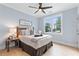 Cozy bedroom features a ceiling fan, large windows, and beautiful hardwood floors at 1671 Laurel Nw Ave, Atlanta, GA 30318
