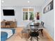 Open-concept dining room with art, a wooden console, natural light and hardwood floors at 1671 Laurel Nw Ave, Atlanta, GA 30318