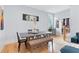 Bright dining room with lots of natural light features hardwood flooring, a large table and modern art at 1671 Laurel Nw Ave, Atlanta, GA 30318