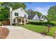 Charming two-story home with a manicured lawn, walkway, and fresh landscaping at 1671 Laurel Nw Ave, Atlanta, GA 30318