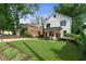 Charming two-story home with a manicured lawn, walkway, and fresh landscaping at 1671 Laurel Nw Ave, Atlanta, GA 30318