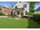 Charming two-story home with a manicured lawn, walkway, and fresh landscaping at 1671 Laurel Nw Ave, Atlanta, GA 30318