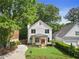 Charming two-story home with a manicured lawn, walkway, and fresh landscaping at 1671 Laurel Nw Ave, Atlanta, GA 30318