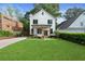 Charming two-story home with a manicured lawn, walkway, and fresh landscaping at 1671 Laurel Nw Ave, Atlanta, GA 30318