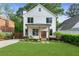 Charming two-story home with a manicured lawn, walkway, and fresh landscaping at 1671 Laurel Nw Ave, Atlanta, GA 30318