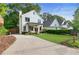 Charming two-story home with a manicured lawn, walkway, and fresh landscaping at 1671 Laurel Nw Ave, Atlanta, GA 30318