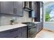 Modern kitchen with white countertops, dark cabinetry, and stainless steel appliances at 1671 Laurel Nw Ave, Atlanta, GA 30318