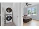 Convenient laundry area featuring a stacked washer and dryer set next to a bright bedroom at 1671 Laurel Nw Ave, Atlanta, GA 30318