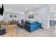 Spacious living room featuring hardwood floors, a modern blue sofa, and lots of natural light at 1671 Laurel Nw Ave, Atlanta, GA 30318