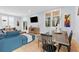 Bright living room featuring a modern blue sofa, artwork, hardwood floors, and large windows at 1671 Laurel Nw Ave, Atlanta, GA 30318
