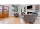 Cozy living room features a fireplace, hardwood floors, and large windows at 1671 Laurel Nw Ave, Atlanta, GA 30318