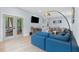 Bright living room featuring a large sofa, hardwood floors, and access to the outdoor patio at 1671 Laurel Nw Ave, Atlanta, GA 30318