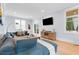 Comfortable living room features large windows, a modern sofa, and beautiful hardwood floors at 1671 Laurel Nw Ave, Atlanta, GA 30318