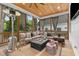 Cozy screened porch featuring a fireplace, comfortable seating, wood floors, and serene backyard view at 1671 Laurel Nw Ave, Atlanta, GA 30318