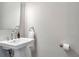 Close up of half bathroom with pedestal sink, modern faucet, and gray walls at 175 Stovall Se St, Atlanta, GA 30316